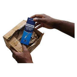 Hands lifting the Pestman carton out of an opened delivery parcel at the door
